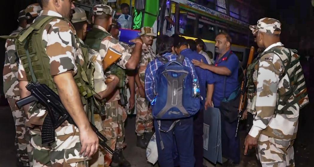 Polling officials carry electoral materials to strong rooms while security personnel keep a vigil, after the conclusion of the West Bengal Assembly elections, at Santipur, in Nadia district, West Bengal, Wednesday.