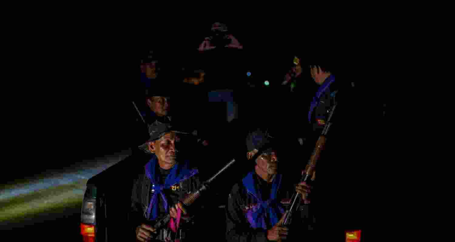 Village security volunteers patrol a village amid deadly clashes between Thailand and Cambodia along a disputed border area, in Buriram province, Thailand.