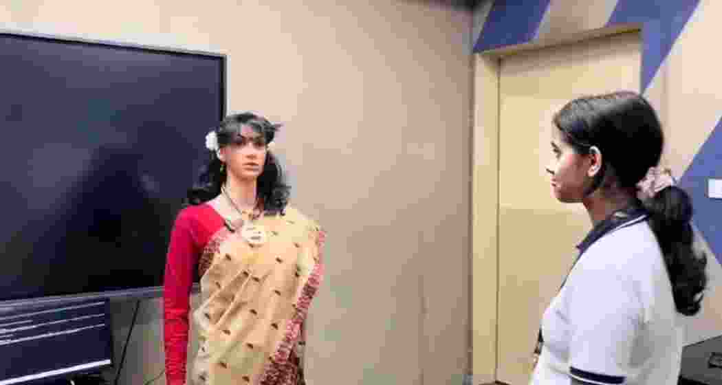 A student interacting with her newly inducted robotic teacher Iris.