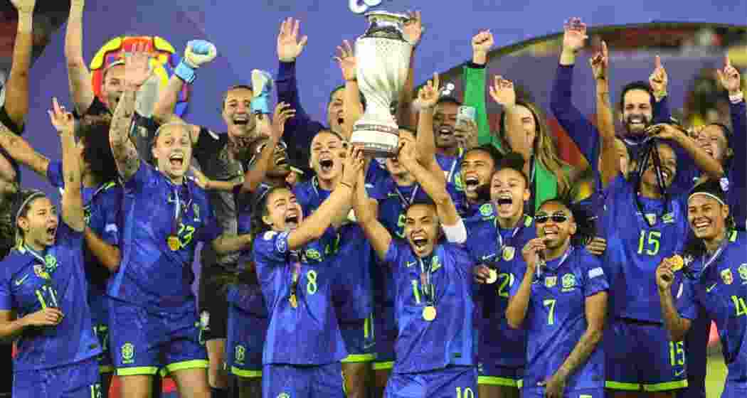Brazilian players lift the Copa America Femenina trophy. Brazilian players lift the Copa America Femenina trophy.