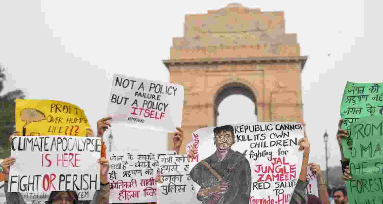A poster with a sketch of top Maoist commander Madvi Hidma at the India Gate protest against toxic air in Delhi. 