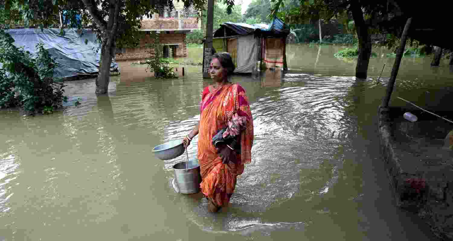 A woman traverses through floodwaters in West Bengal.