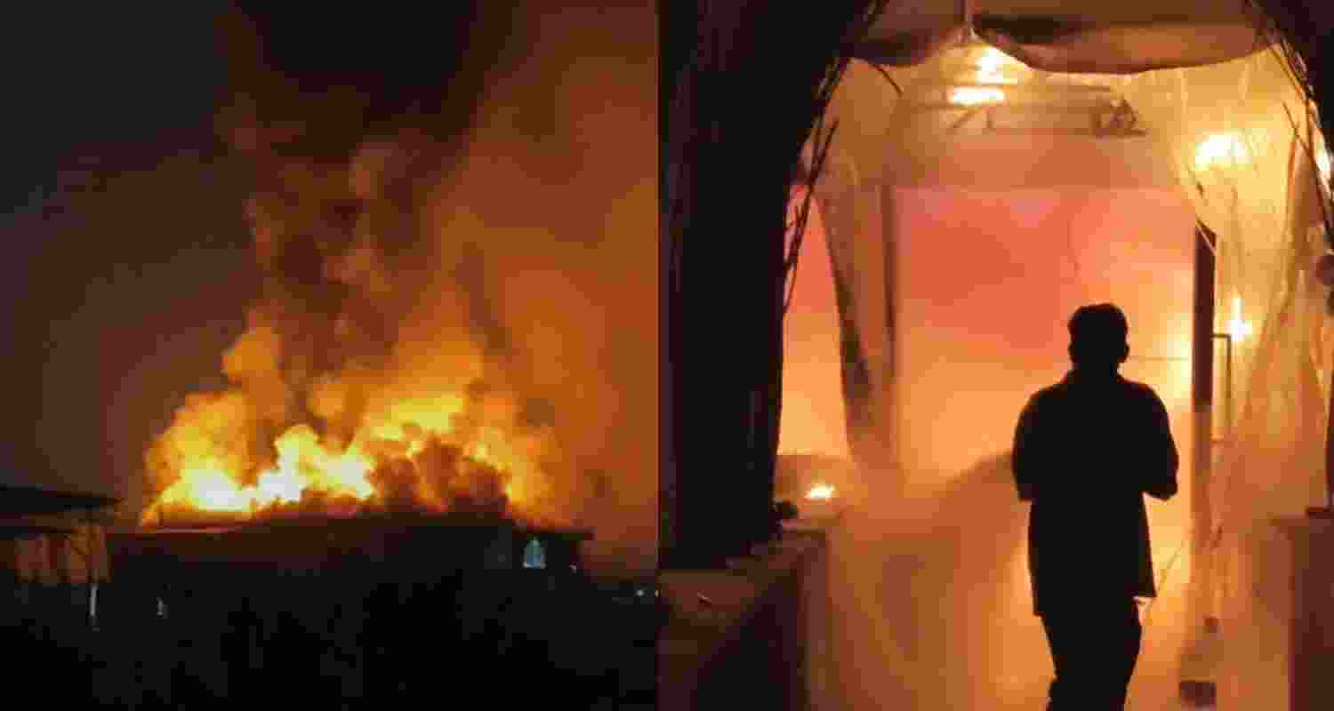 A fire fighter attempts to contain a fire at a nightclub early Sunday, in Arpora, in Goa, India, Sunday.