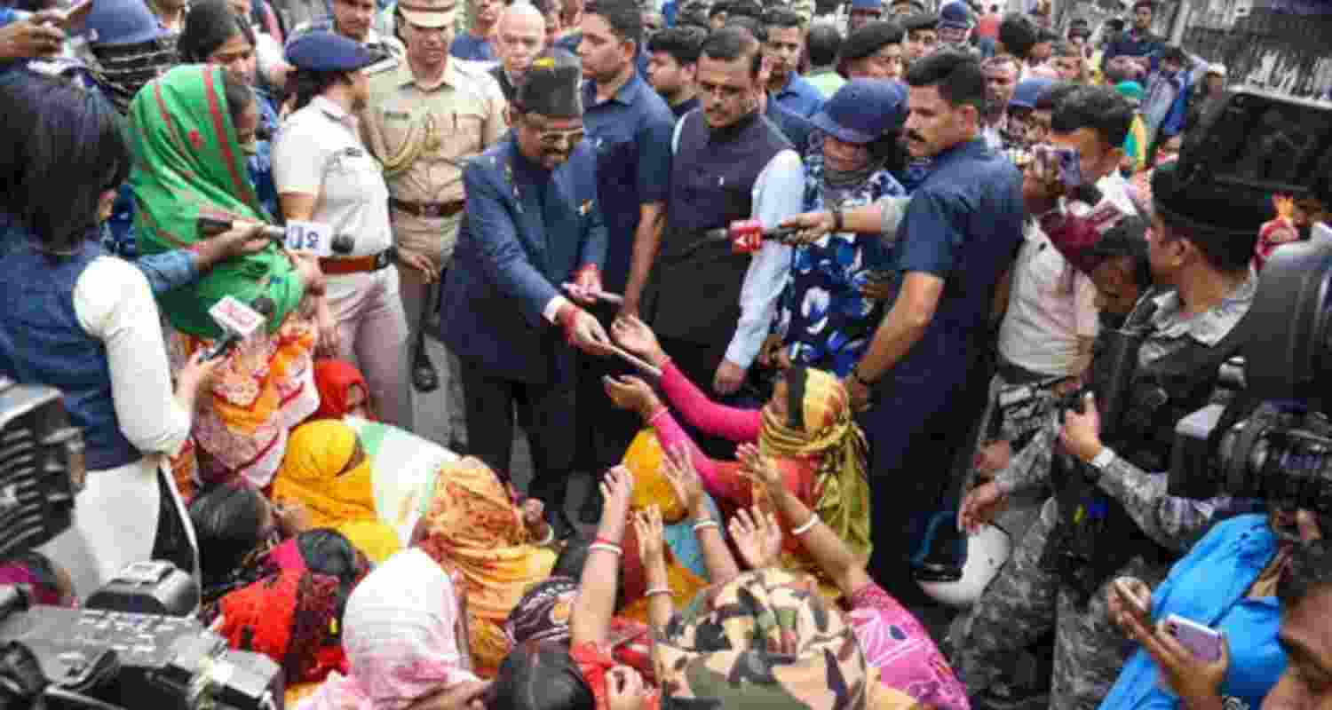 West Bengal Governor CV Ananda Bose with women protestors and others at Sandeshkhali block, in North 24 Parganas district on Monday, Feb. 12, 2024.