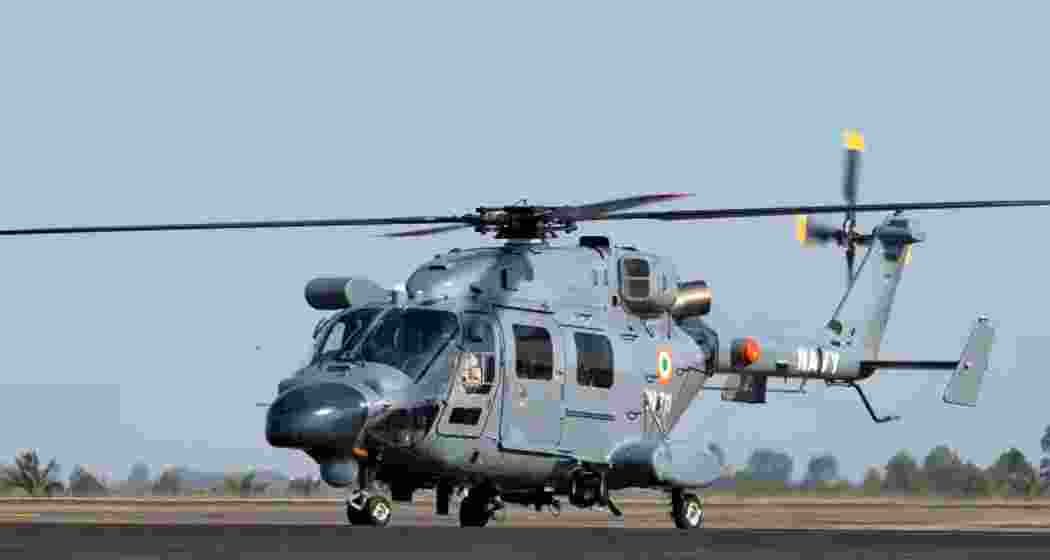 An ALH Dhruv helicopter rests on the runway after operations. 