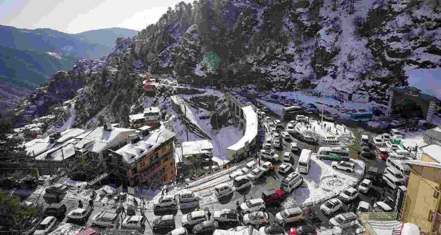 Vehicles remain stuck in a traffic jam after snowfall, in Shimla, Himachal Pradesh, Sunday