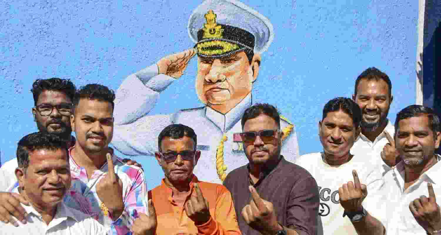 Voters show their ink-marked fingers after casting their votes at a polling station during the Brihanmumbai Municipal Corporation elections in Mumbai, Maharashtra