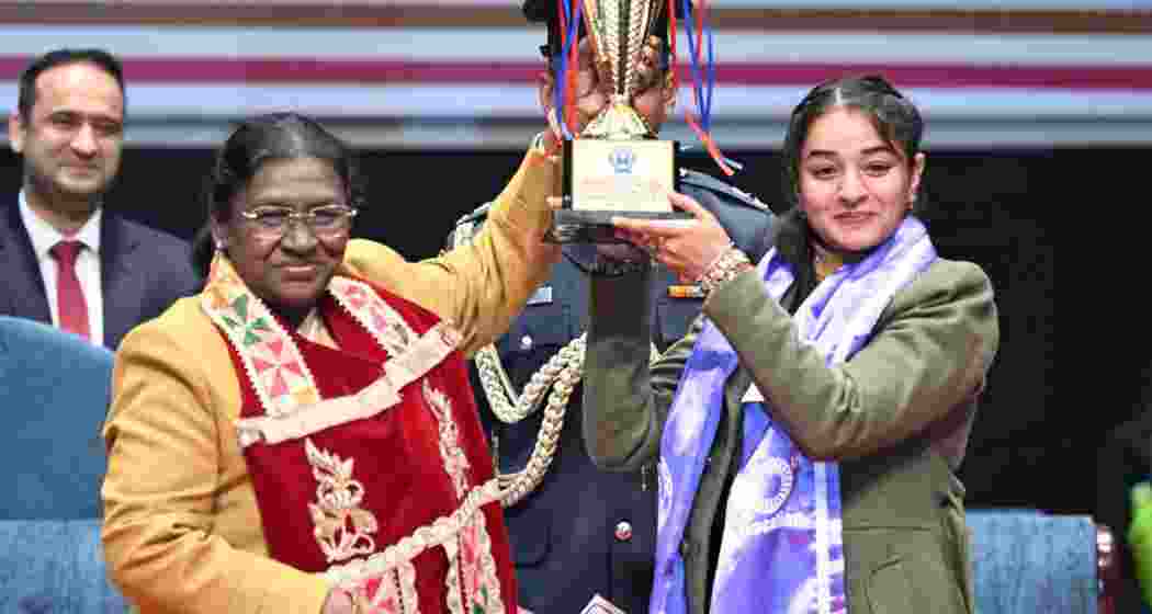 President Droupadi Murmu presents a trophy to an achiever at the convocation ceremony of Guru Nanak Dev University in Amritsar on Thursday.