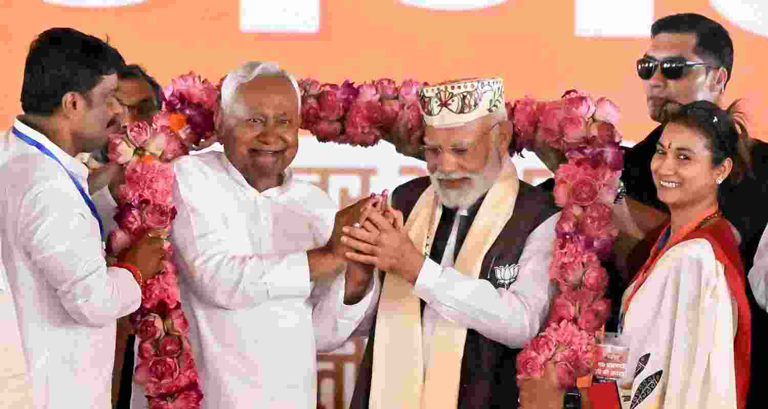 Prime Minister Narendra Modi and Bihar Chief Minister Nitish Kumar being garlanded during a public meeting ahead of the state Assembly elections, in Samastipur district, Friday.