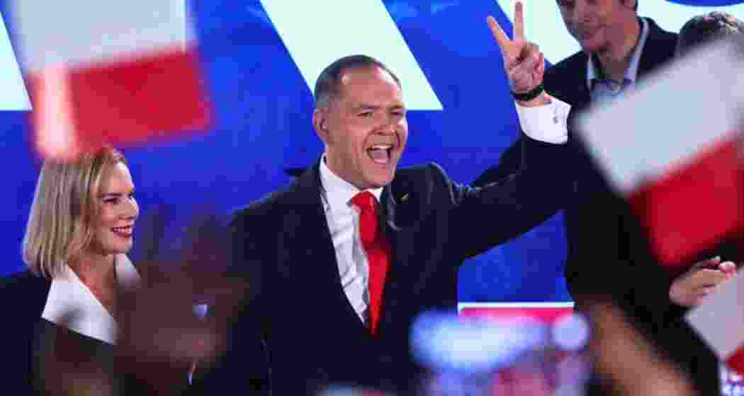 Presidential candidate Karol Nawrocki, a conservative historian, greets supporters at his headquarters after the presidential election runoff in Warsaw, Poland, Sunday, June 1, 2025.