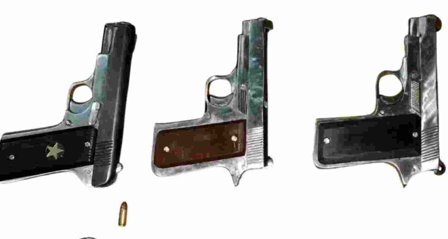 Seized .32 calibre pistols with live cartridges from the accused. 