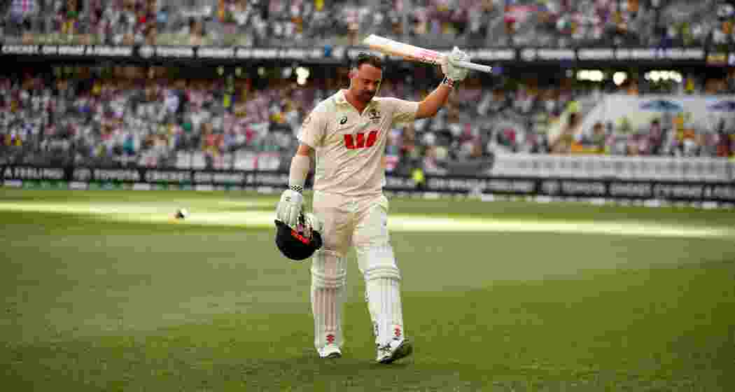 Australia's Travis Head acknowledges the applause as he leaves the ground after losing his wicket on day two of the first Ashes cricket test match between Australia and England in Perth on Saturday.