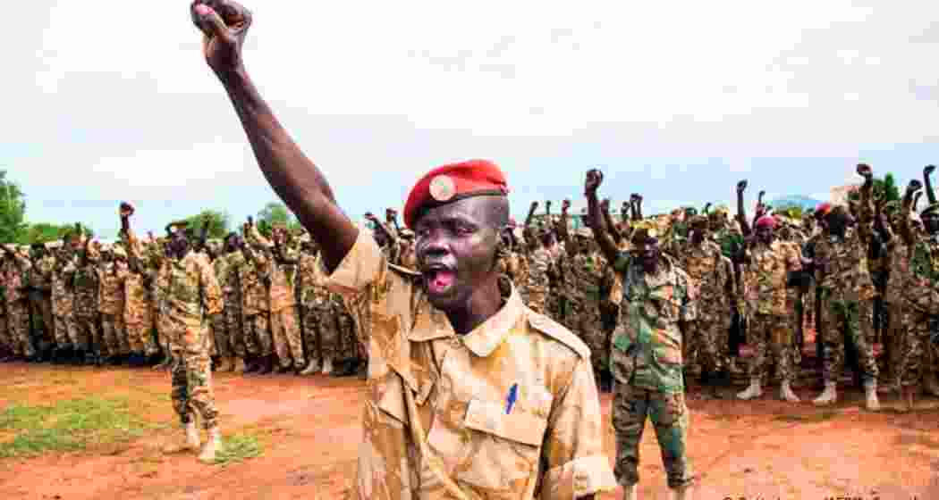 Ugandan soldiers stationed near the South Sudan border raise a battle cry during field drills. 