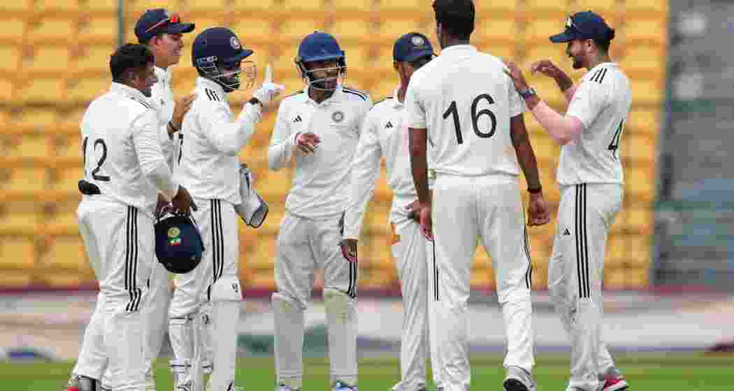 India B team bowler Washington Sunder celebrates with teammates the wicket of India A batter Kuldeep Yadav during the fourth day of the Duleep Trophy 2024 match between India A and India B at Chinnaswamy Stadium, in Bengaluru, Sunday, Sept. 8, 2024.