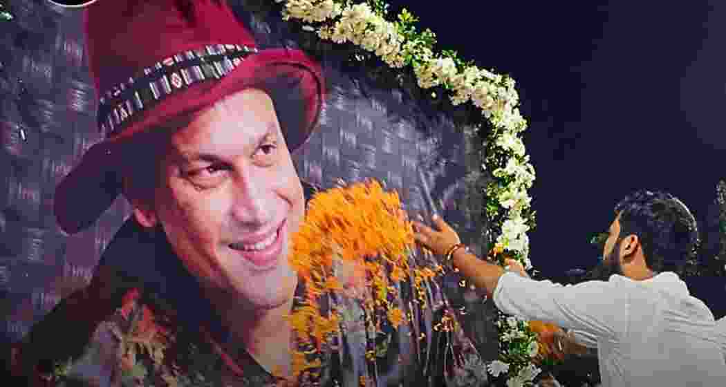 A fan pays tribute to late singer Zubeen Garg, offering flowers and respects at a memorial site in Guwahati.
