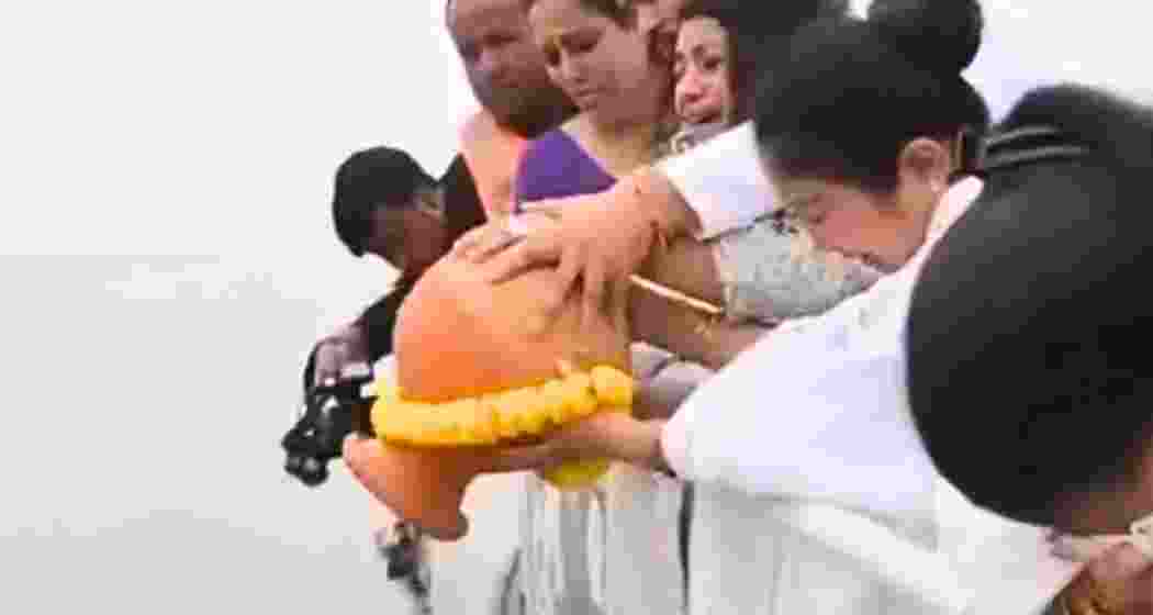 Garima Garg immerses the ashes of her late husband, Zubeen Garg, in the Brahmaputra River. 