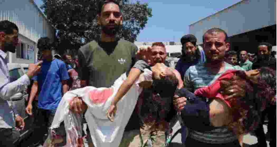 Palestinians carry injured civilians after Israeli strikes hit aid seekers near the Netzarim Corridor in Gaza, as fresh bombardments killed at least 92 people across the besieged territory.