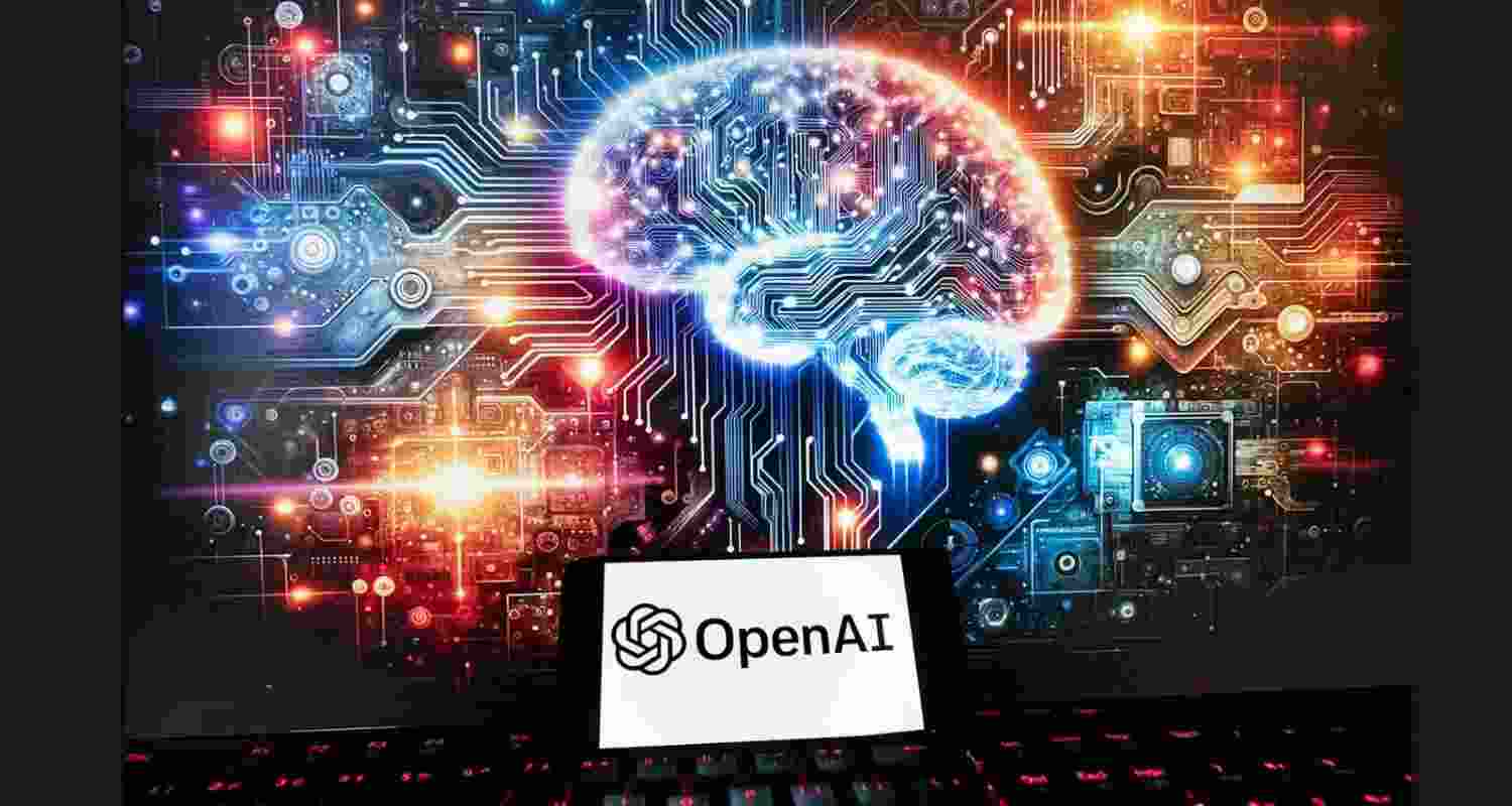 The OpenAI logo is displayed on a cell phone with an image on a computer monitor generated by ChatGPT’s Dall-E text-to-image model in 2023 in Boston.