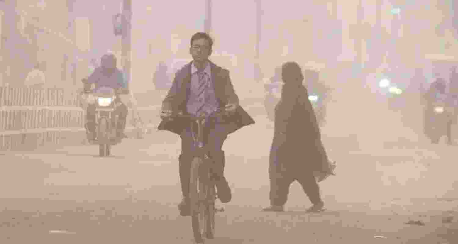 Commuters make their way amid low-visibility as air quality continues to deteriorate in Delhi-NCR, in Gurugram, Thursday.