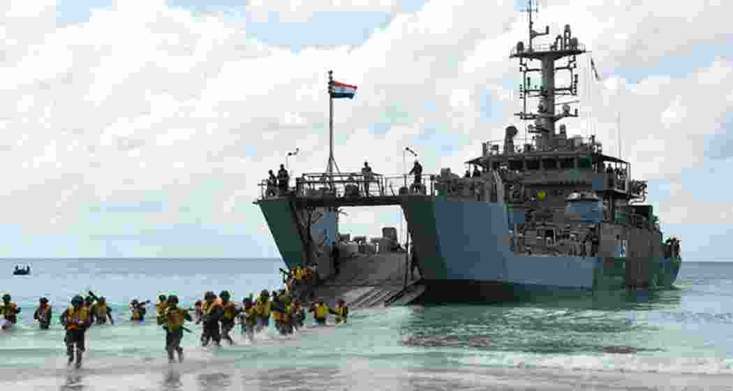 Soldiers deboard an amphibious vessel of the Indian Navy.