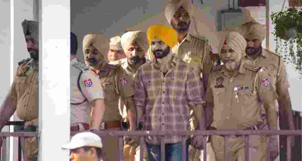 Daljit Singh Kalsi, an aide of Waris Punjab De chief Amritpal Singh, being escorted under heavy security after being remanded to police custody in Punjab.