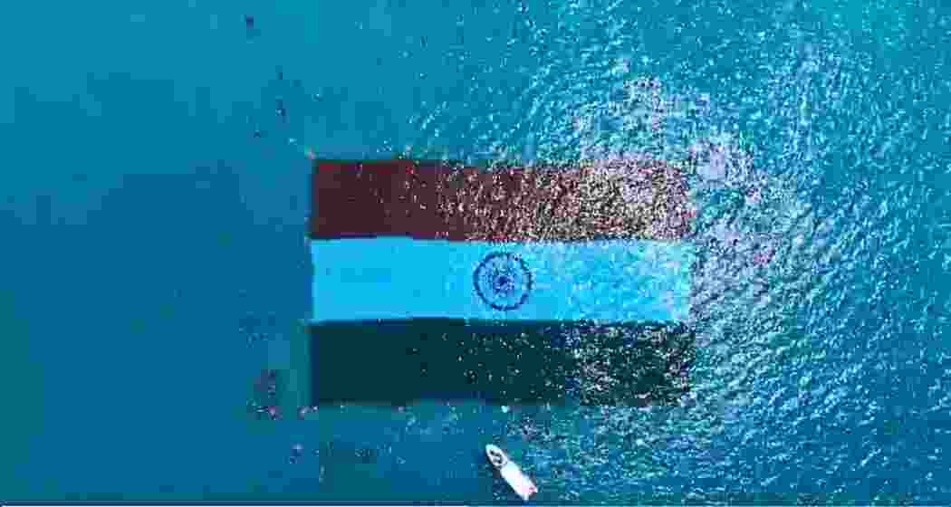 Divers deploy a massive 60x40 metre Indian Tricolour underwater at Radhanagar Beach on Swaraj Dweep.