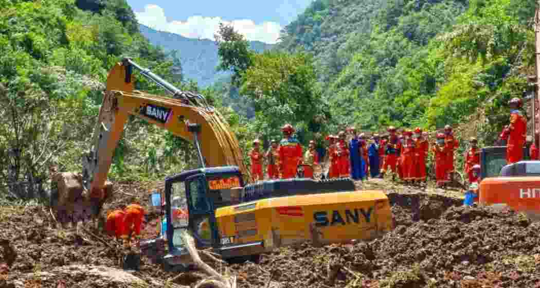 Rescue personnel clear debris after a rain-triggered landslide at a construction site in Lohit district, Arunachal Pradesh, where two Bihar labourers were killed and four others injured.