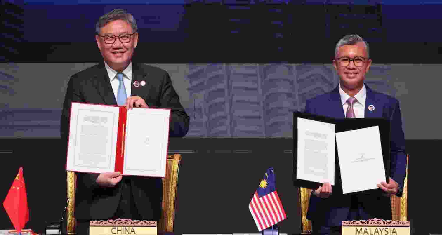 Malaysia Trade Minister and ASEAN Economic Minister Chairman, Tengku Zafrul Aziz and Chinese Commerce Minister Wang Wentao show agreement documents after signing of the ASEAN-China Free Trade Area 3.0 Upgrade ahead of the 28th ASEAN–China Summit, held as part of the 47th ASEAN Summit. Malaysia Trade Minister and ASEAN Economic Minister Chairman, Tengku Zafrul Aziz and Chinese Commerce Minister Wang Wentao show agreement documents after signing of the ASEAN-China Free Trade Area 3.0 Upgrade ahead of the 28th ASEAN–China Summit, held as part of the 47th ASEAN Summit.