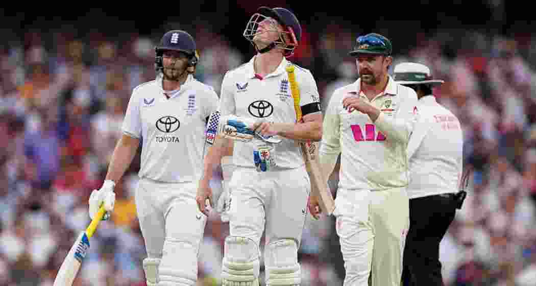 England’s Harry Brook and Joe Root, and Australia’s Travis Head, walk off the field after bad light stops play on day one of the fifth Ashes Test at the SCG.