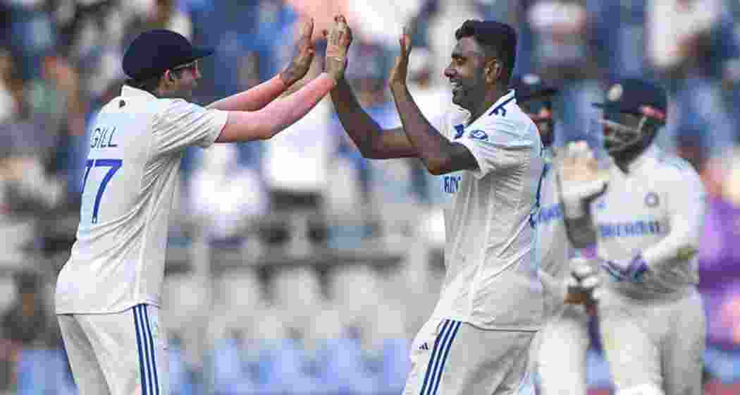 Indian cricketers Shubman Gill and Ravichandran Ashwin celebrate a crucial wicket in the final Test, energising their team’s defence on the field.