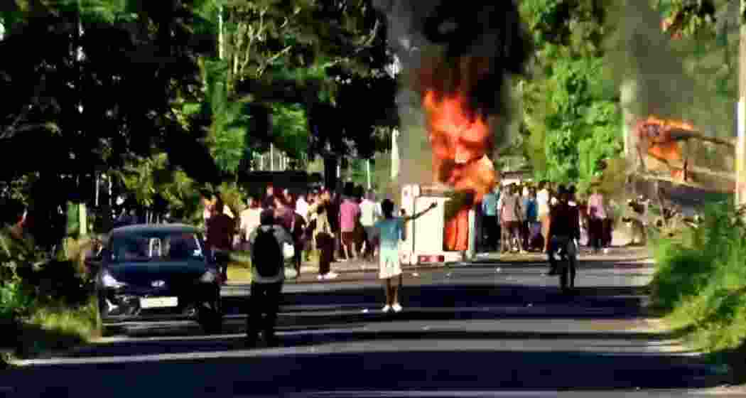 Irked protestors torch a van and hurl stones at police outside Baksa jail during transfer of accused in Zubeen Garg’s death case. 