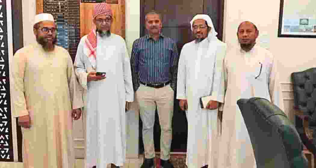 Dr Asif Nazrul (C) pictured moments before his meeting with LeT operative Harun Izhar, who stands beside him with his head draped in a white cloth, inside Dhaka’s Ministry of Law.