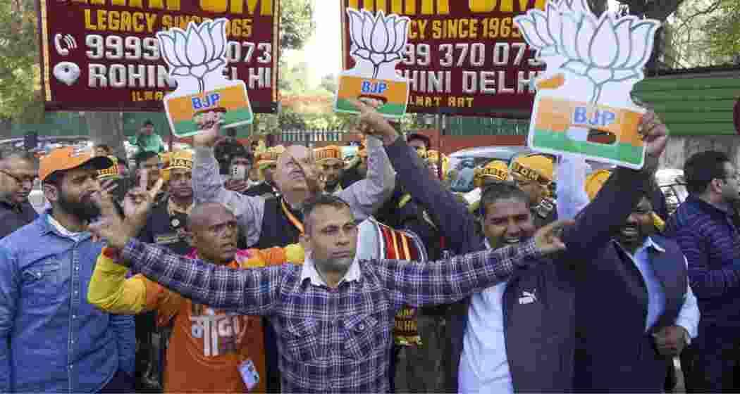  BJP supporters celebrate the party's lead in Delhi Assembly polls during counting of votes, in New Delhi on Saturday, Feb. 8, 2025.