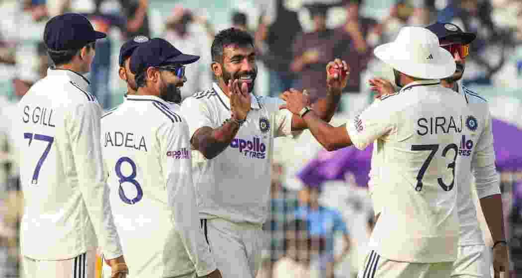 India's Jasprit Bumrah celebrates with teammates after taking his fifth wicket during the first day of the first Test cricket match between India and South Africa, at the Eden Gardens, in Kolkata on Friday.
