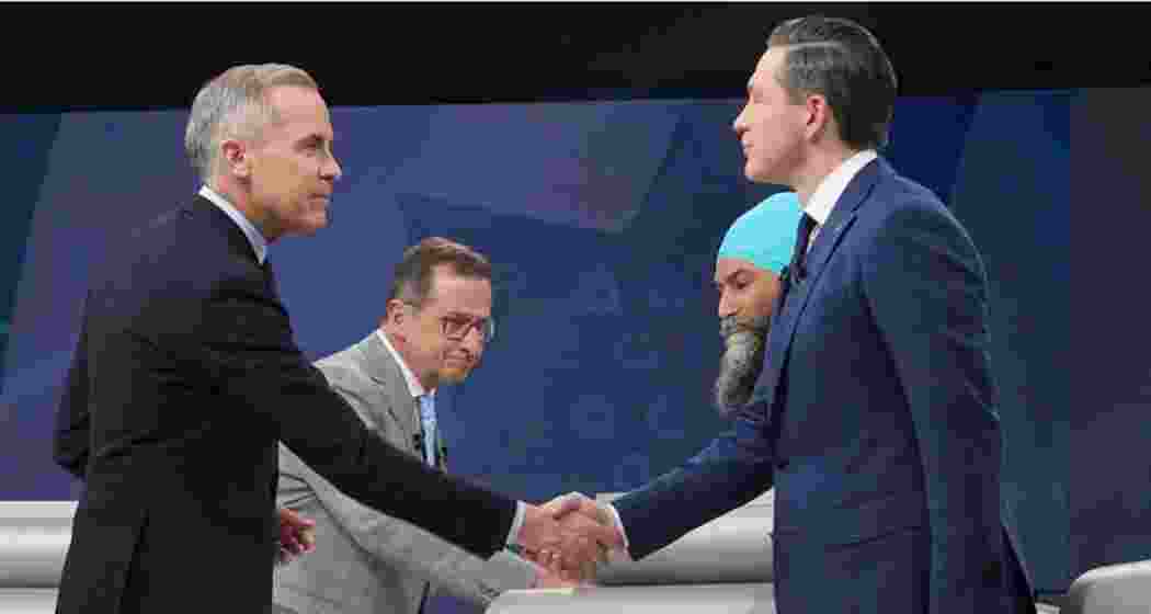 Liberal Leader Mark Carney shakes hands with Conservative Leader Pierre Poilievre following the French-language federal leaders' debate, in Montreal.