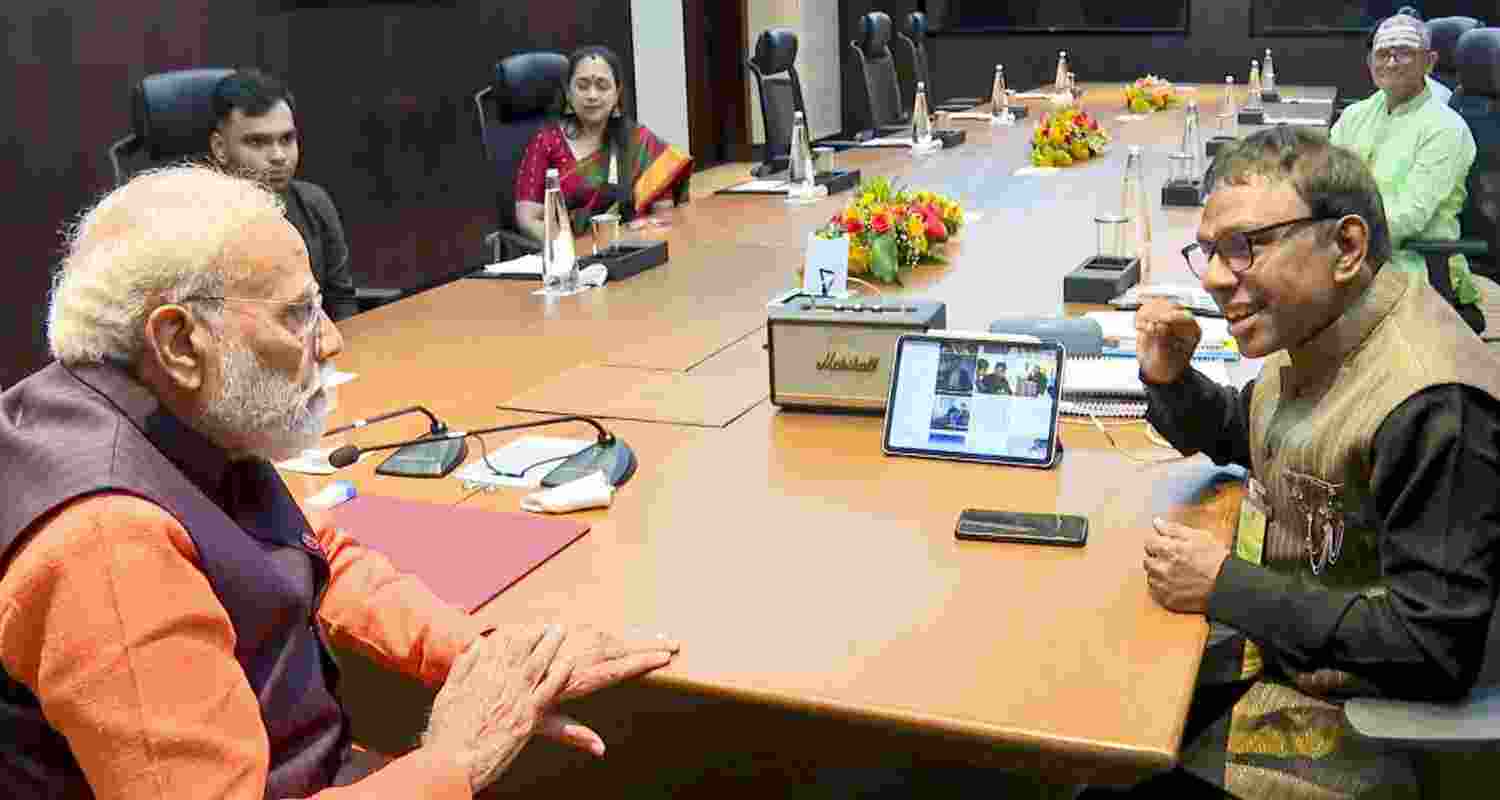 Prime Minister Narendra Modi, left, interacts with music composer Ramesh Vinayakam during a meeting, in Chennai, Tamil Nadu.