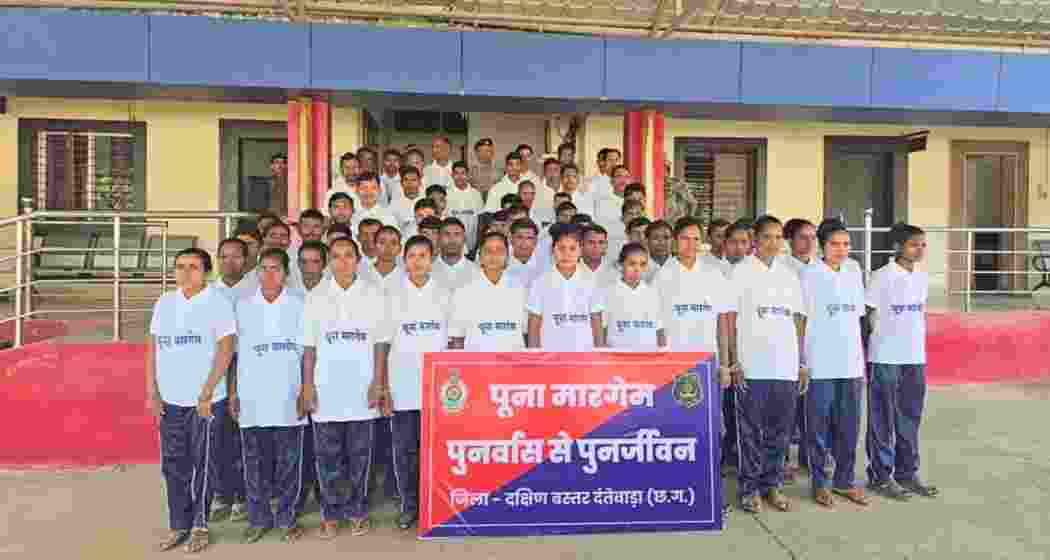 Surrendered Naxalites stand with senior police and CRPF officials in Dantewada on Friday after laying down arms under the state’s ‘Poona Margem’ rehabilitation initiative.