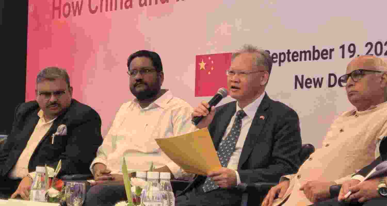 Chinese ambassador Xu Feihong answering questions at an event.