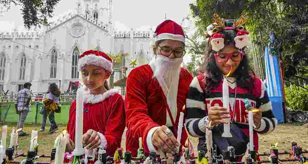 Devotees light candles during Christmas celebrations at a church, in Kolkata, West Bengal on Wednesday, Dec. 25, 2024.