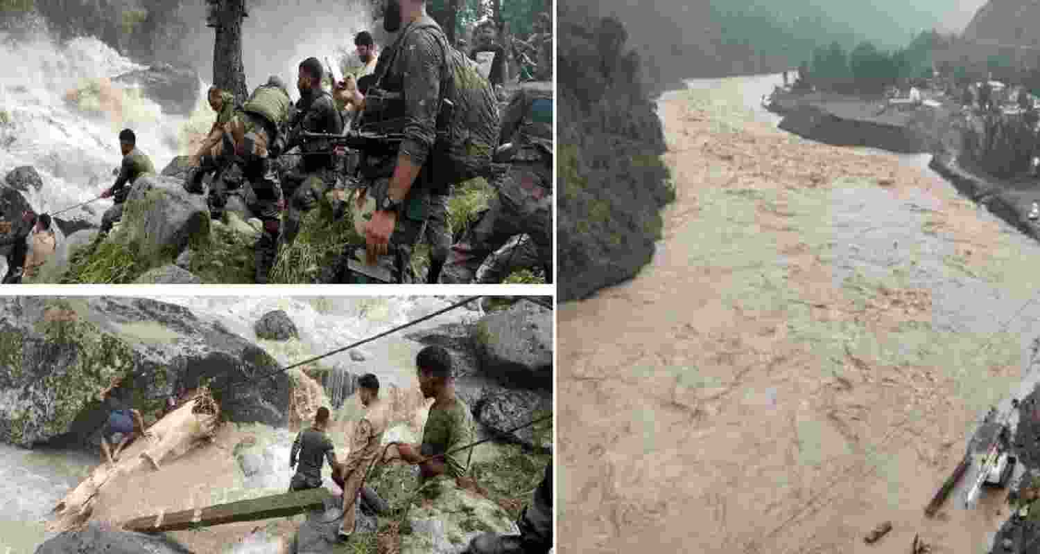 People move through the debris after a massive cloudburst at Chasoti village, in Jammu and Kashmir's Kishtwar district on Friday.