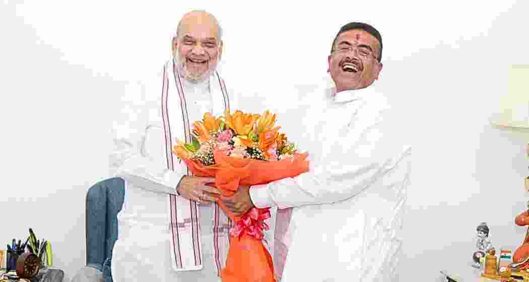 West Bengal Chief Minister Suvendu Adhikari (R) greets Union Home Minister Amit Shah in New Delhi on Friday.