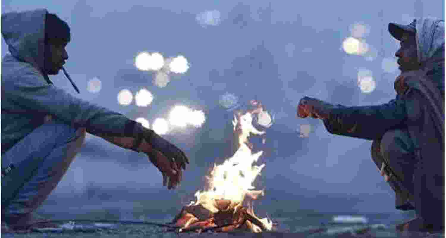 People seen out on a cold morning at New Delhi Railway Station in New Delhi on Thursday. 