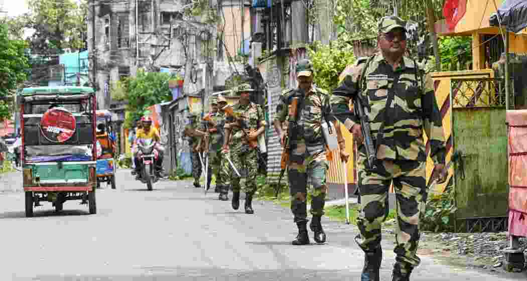 Security personnel conduct a route march ahead of the declaration of results of the West Bengal Assembly elections, at Raiganj, in Uttar Dinajpur district, on Thursday.