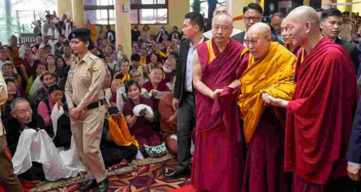 Tibetan spiritual leader Dalai Lama arriving at the main Tibetan temple in McLeodganj, Tsuglhakhang, assisted by monks, on the eve of his 90th birth anniversary on Saturday.