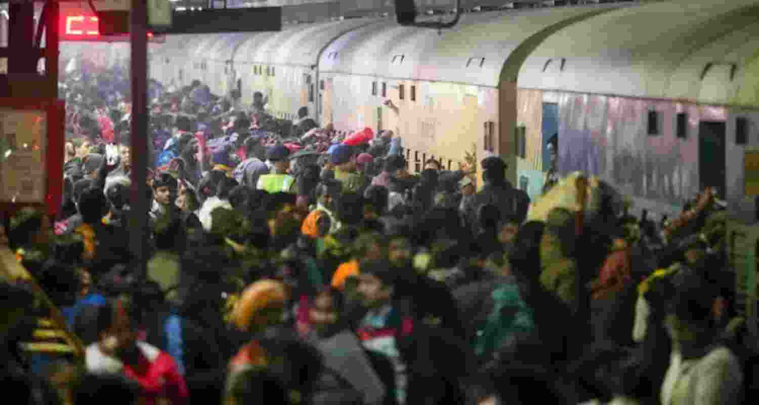 Passengers board an overcrowded train for Prayagraj's Maha Kumbh, at the New Delhi railway station on February 15. 