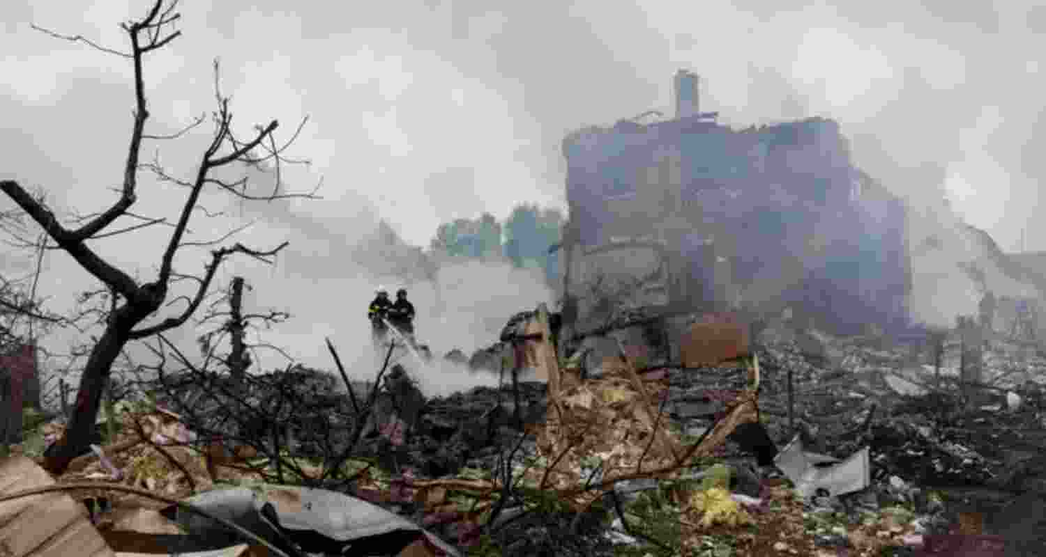 Emergency workers extinguish fire in the debris of a private house that was destroyed in a Russian rocket strike, amid Russia's attack on Ukraine, in Markhalivka, Kyiv region, Ukraine.