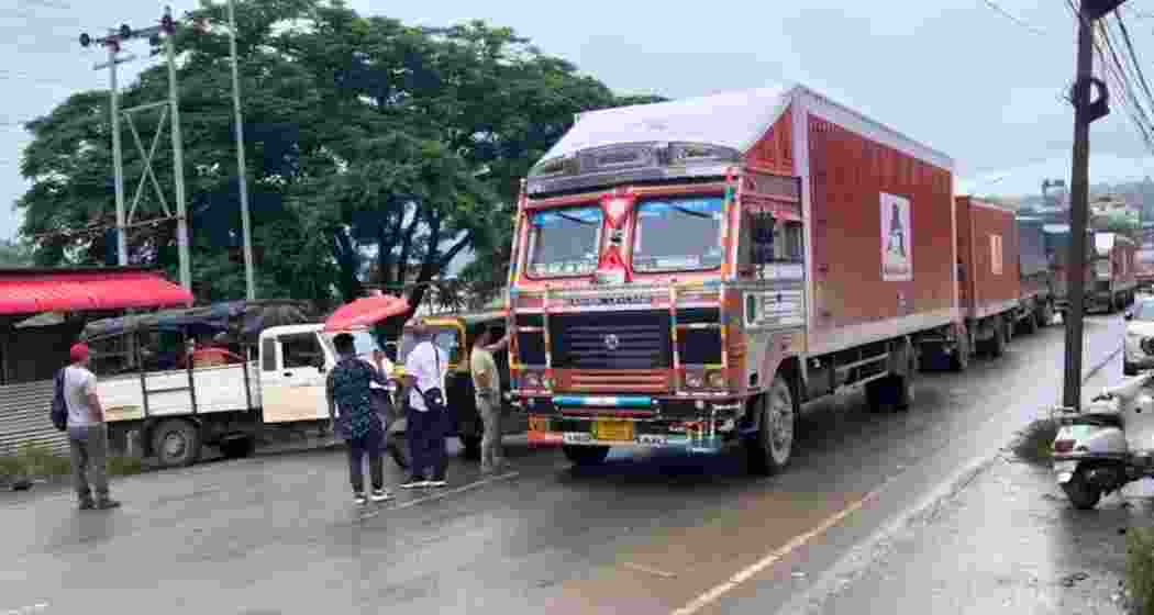 Kuki civil society members halt vehicular movement during their blockade along NH-2.