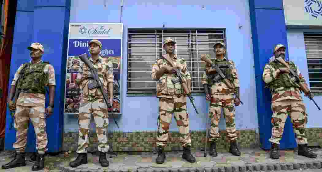 Security personnel stand guard outside a strong room, ahead of the counting of votes for the West Bengal Assembly elections, at the Khudiram Anushilan Kendra, in Kolkata, on Saturday.