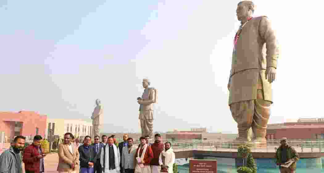 People pose in front of the Rashtriya Prerna Sthal in Lucknow, showcasing the newly inaugurated bronze statues of Vajpayee, Mookerjee, and Upadhyaya. 