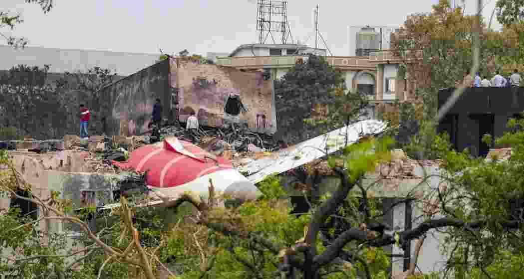 Remains of the crashed Air India plane lie on a building, in Ahmedabad, on Friday. A London-bound Air India plane carrying 242 passengers crashed moments after taking off from the Ahmedabad airport on Thursday.